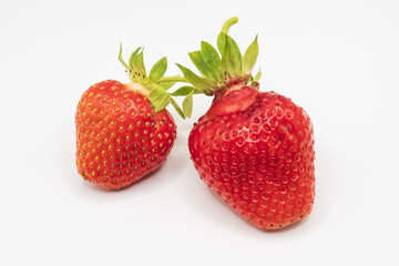 Ripe red strawberries isolated on white background with fresh organic berries and detailed natural texture close up © Olha