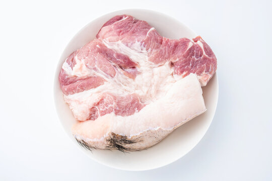 A piece of fresh black-haired pork on a white plate