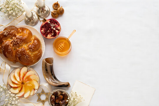Rosh Hashanah Jewish New Year Flat Lay with Honey Apple Challah Pomegranate Sufganiyot Sweet New Year Copy Space