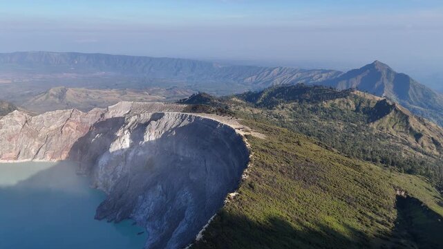Drone Aerial view of the landscape of mountains and volcano crater lake of Kawah Ijen volcano, East Java of Indonesia.