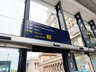 Obraz premium Lime Street station interior with directional signage, glass canopy and tourist information at Liverpool, UK