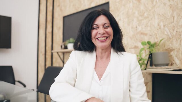 Middle aged business woman talking and gesturing on a video call. Computer point of view of a manager in a virtual meeting in office
