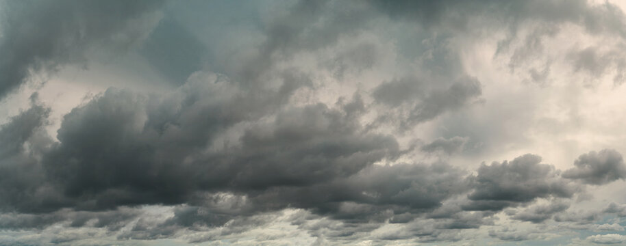 Panorama view of overcast sky. Dramatic gray sky and white clouds before rain in rainy season. Cloudy and moody sky. Storm sky. Cloudscape. Gloomy and moody background. Overcast clouds.