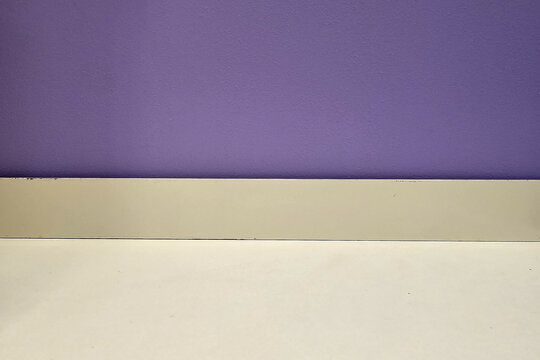 Minimalist Product Display Mockup with Vibrant Purple Wall and Neutral Floor.