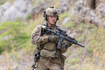Fototapeta premium Military participate in a patrol in a rocky terrain