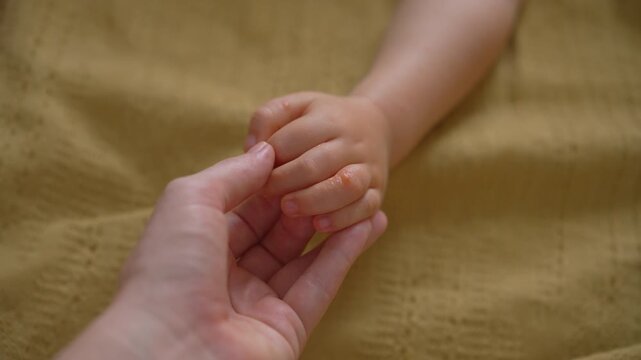 Red blister-like spots on child fingers and hand. Close-up.