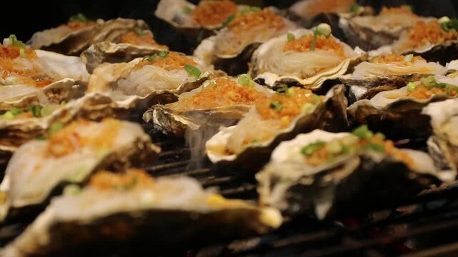 Oyster shell grill charcoal seafood garlic butter breadcrumb grilled oysters half shell with garlic butter breadcrumb green onion sizzling smoky