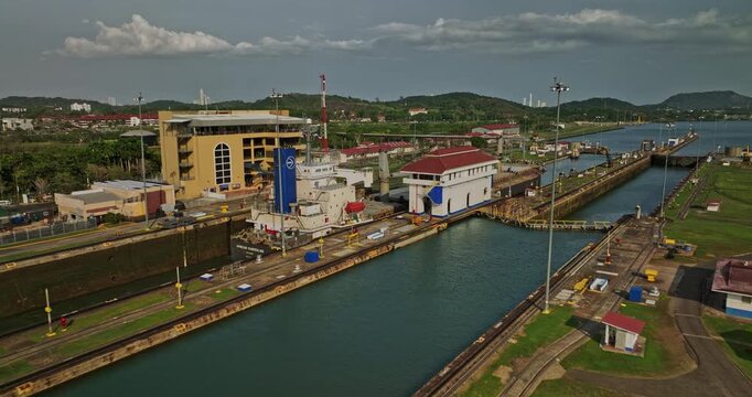 Panama City Aerial v39 establishing low level flyover tourist attraction miraflores locks canal with cargo tanker ship transiting at the waterway during daytime - Shot with Mavic 3 Cine - March 2022