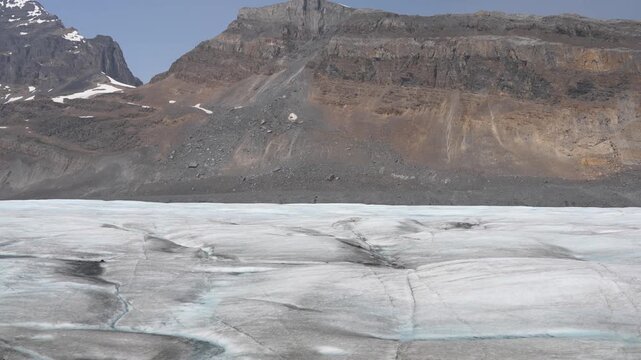 Stunning summer season view of Athabasca Glacier flowing from Columbia Icefield surrounded by alpine peaks Alberta wilderness