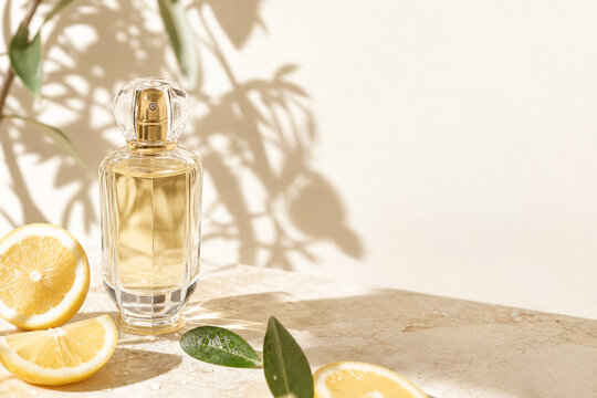 Luxury glass perfume bottle with golden liquid on cream stone surface, surrounded by sliced lemons and water droplets, natural sunlight casting botanical shadows, Mediterranean summer mood