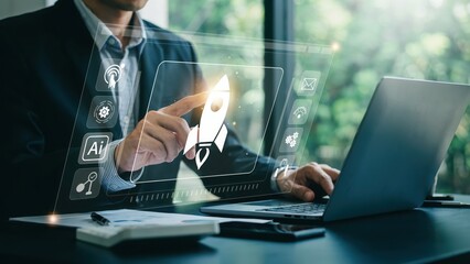 Fototapeta premium Businessman using digital tablet with creative software icons in a modern office