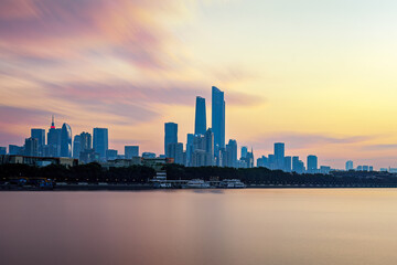 Fototapeta premium Guangzhou City Skyline at Sunrise Over Water