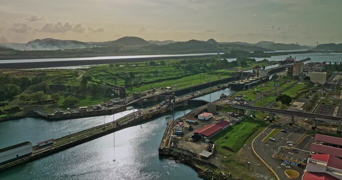 Panama City Aerial v40 low level fly around miraflores locks capturing hydraulic structure facility with cargo ship transiting and waiting for sluice gate to open - Shot with Mavic 3 Cine - March 2022