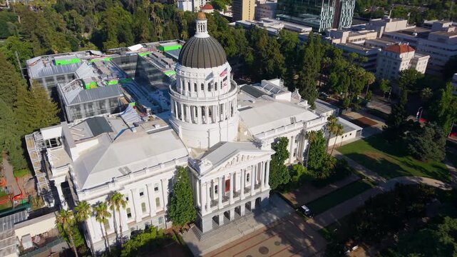 Aerial perspective shows west side of California State Capitol and ongoing annex construction to the east in Sacramento, CA.