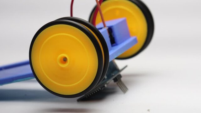 Wheels connected to dc motor shaft tested with motor controller. Testing the wheels of robotic car