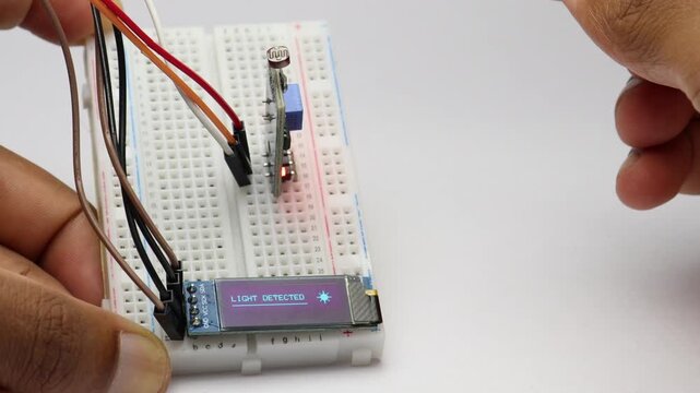 LDR sensor module working with OLED display showing light status