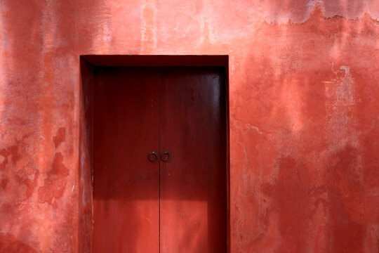 Red Door with Textured Wall