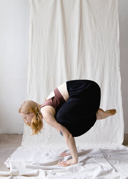 Woman practicing yoga in a studio 