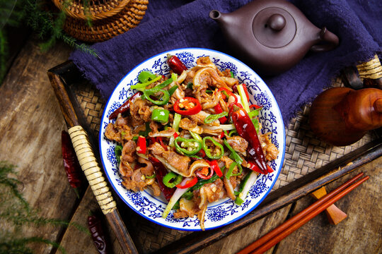 Spicy Stir Fried Pork Ribs with Chili Peppers on Traditional Asian Table