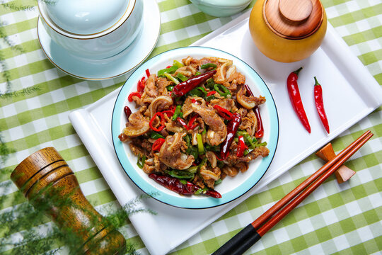 Spicy stir fried pork ribs with chili peppers and green onions