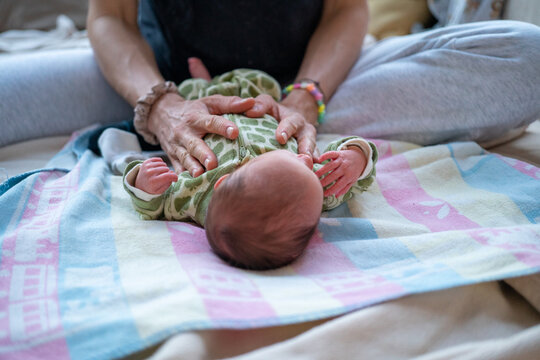 Mother holding her newborn daughter 
