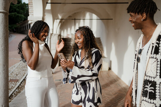 Friends using mobile phones in the city