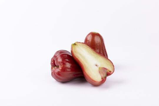 Red wax apples with cut half isolated on white background