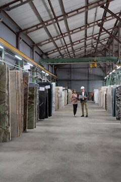 Male and Female Architects working in marble warehouse