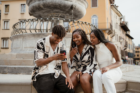 Friends using mobile phones in the city