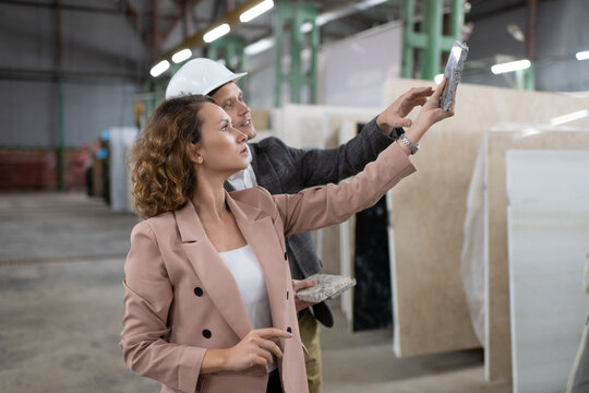 Contractor with architect in warehouse with marble