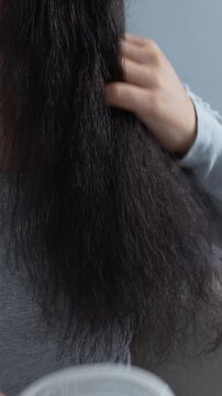 woman sticking brushing her hair falling out and have many hair loss on the comb. problem of Damaged and frizzy. Healthcare and medical concept.