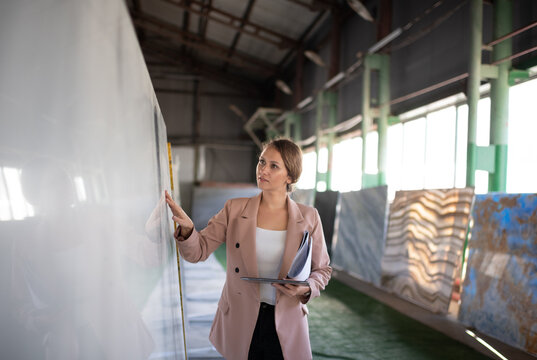 Elegant adult woman visiting showroom of stone company