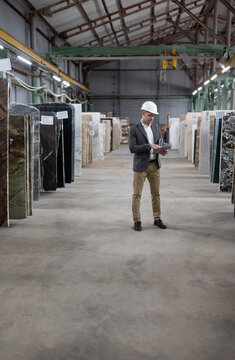Male architect using tablet in warehouse