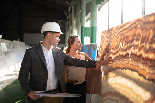 Male Worker of stone warehouse with female client