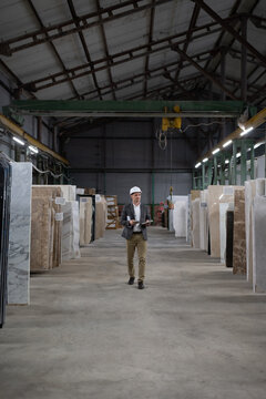 Male architect walking in warehouse