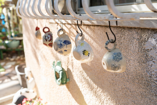 Hanging Ceramic Pots on a Wall in a Garden Setting Outdoors