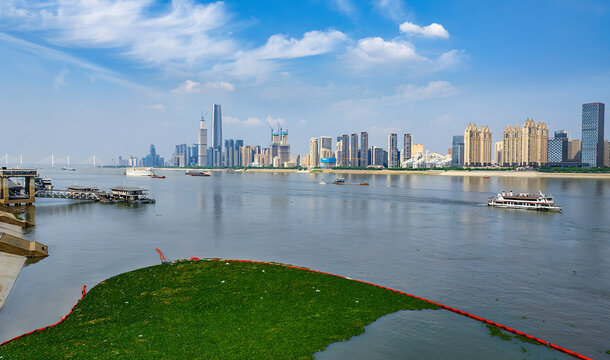 Wuhan Hanjiang River Waterfront with City Skyline and Water Management Fence