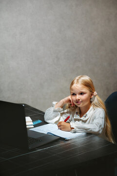 Child girl learning in online school using laptop homeschooling digital education platform class, kid writing studying primary grade course selfstudy at home modern technology getting knowledges