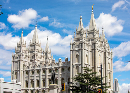 Newly restored exterior of Salt Lake City LDS temple in Utah with beautiful fluffy clouds on a blue sky in summer