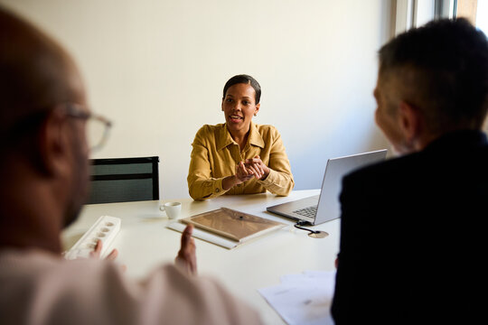 Woman sits with her corporate partners