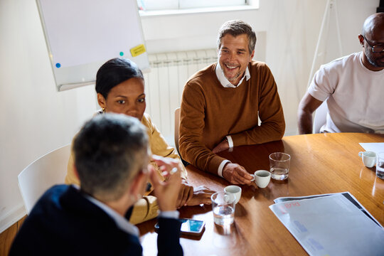 Colleagues chat at the conference table