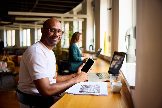 Smiling man works in a contemporary workspace