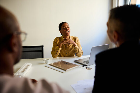 Woman sits with her corporate partners