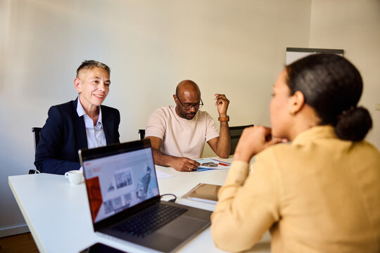 Woman sits with her corporate partners