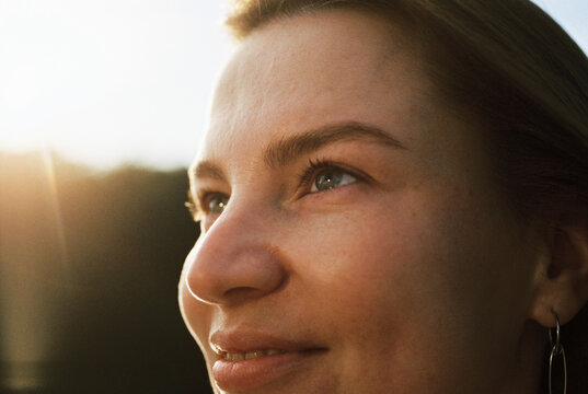 A woman gazes upward bathed in golden afternoon light