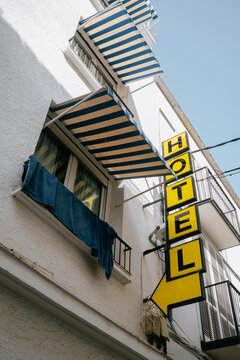 Yellow Hotel Sign with Blue Awnings