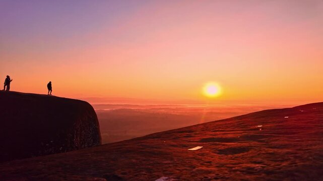 Epic dawn scenery at Hin Sam Wan viewpoint featuring tiny human figures standing atop a colossal sandstone formation surrounded by forests, hills, and morning mist. Three Whale Rock