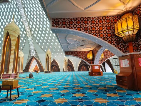 Bandung, Indonesia - July 08, 2026: An interior corner of Al Jabbar Grand Mosque showing a large hanging lamp pillar geometric ornaments and grand ceiling