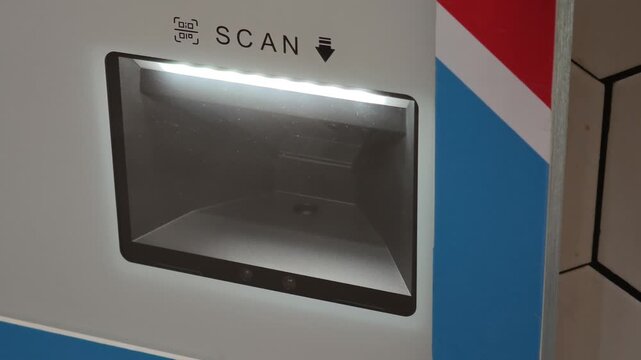 Close up of a modern self service payment terminal with a blinking light. Technology for scanning QR codes and barcodes for quick checkouts