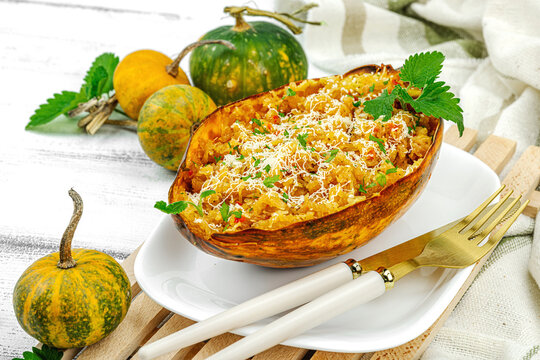 Baked spaghetti squash with spices, herbs and tomato sauce. Gluten free food, healthy dinner, vegan